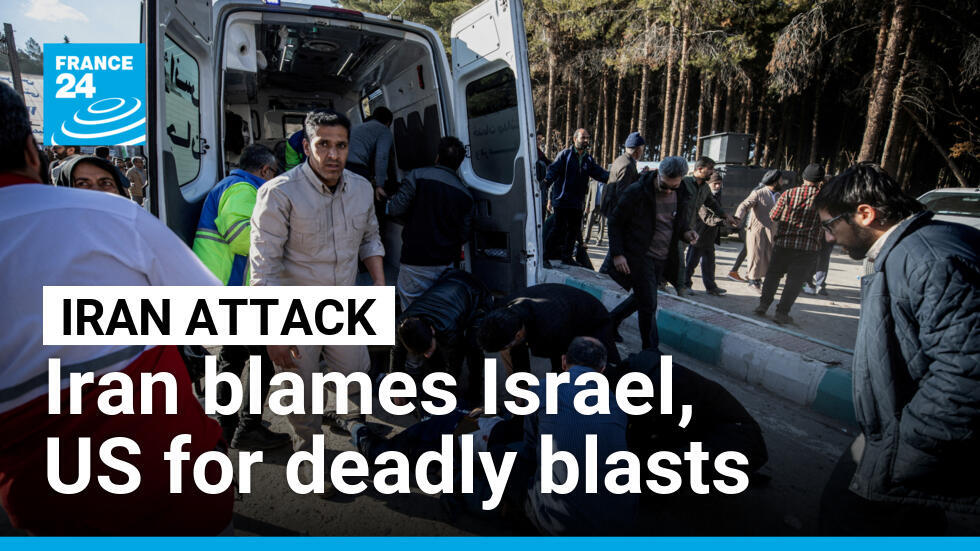 People gather near a body on the ground at the scene of two explosions during a ceremony held to mark the death of late Iranian general Qassem Soleimani in Kerman, Iran on January 3, 2024.